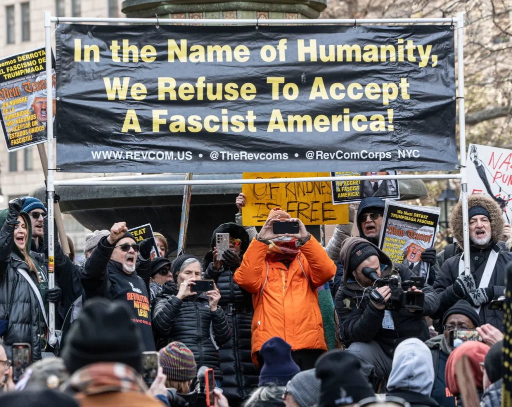 During a recent protest, many people surrounded a huge banner that states: "In the Name of Humanity, We Refuse To Accept A Fascist America!"